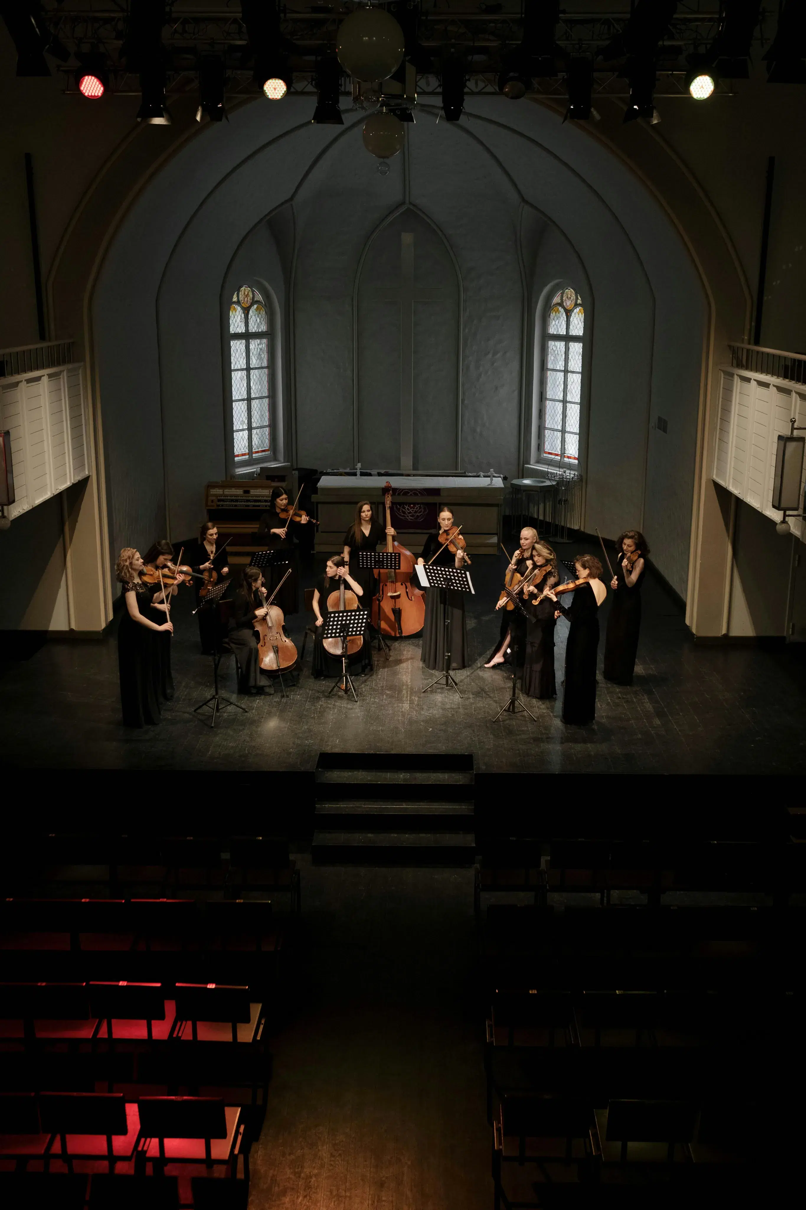 Small chamber ensemble musicians collaborating in intimate musical performance setting