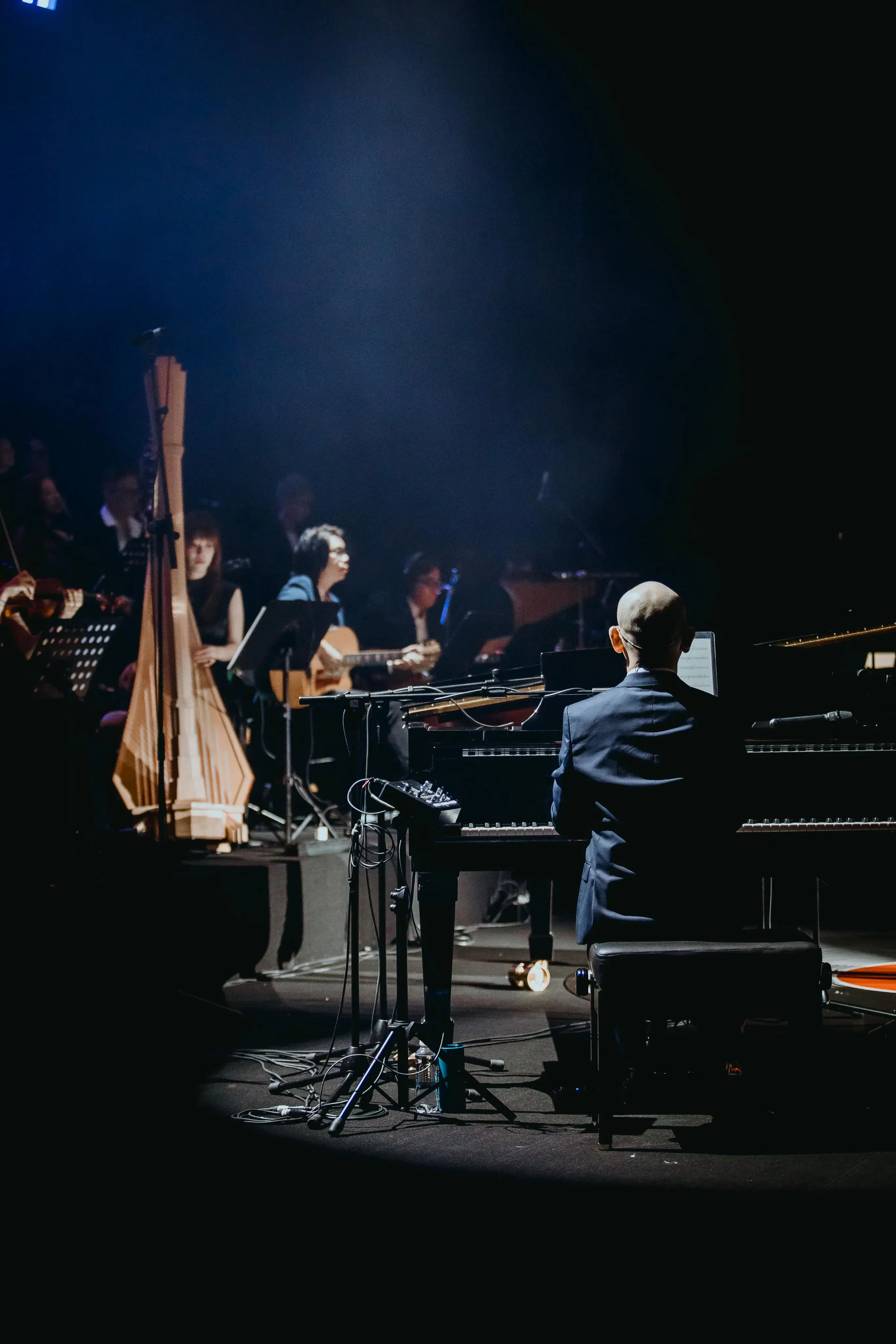 Community orchestra musicians performing together with string sections and conductor